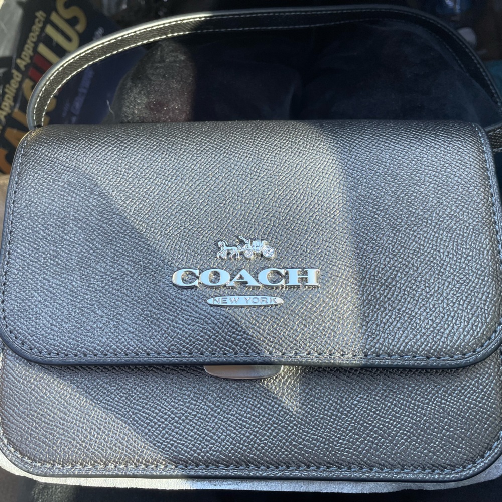 Black Coach purse never been worn or used the tag is still protected no damage